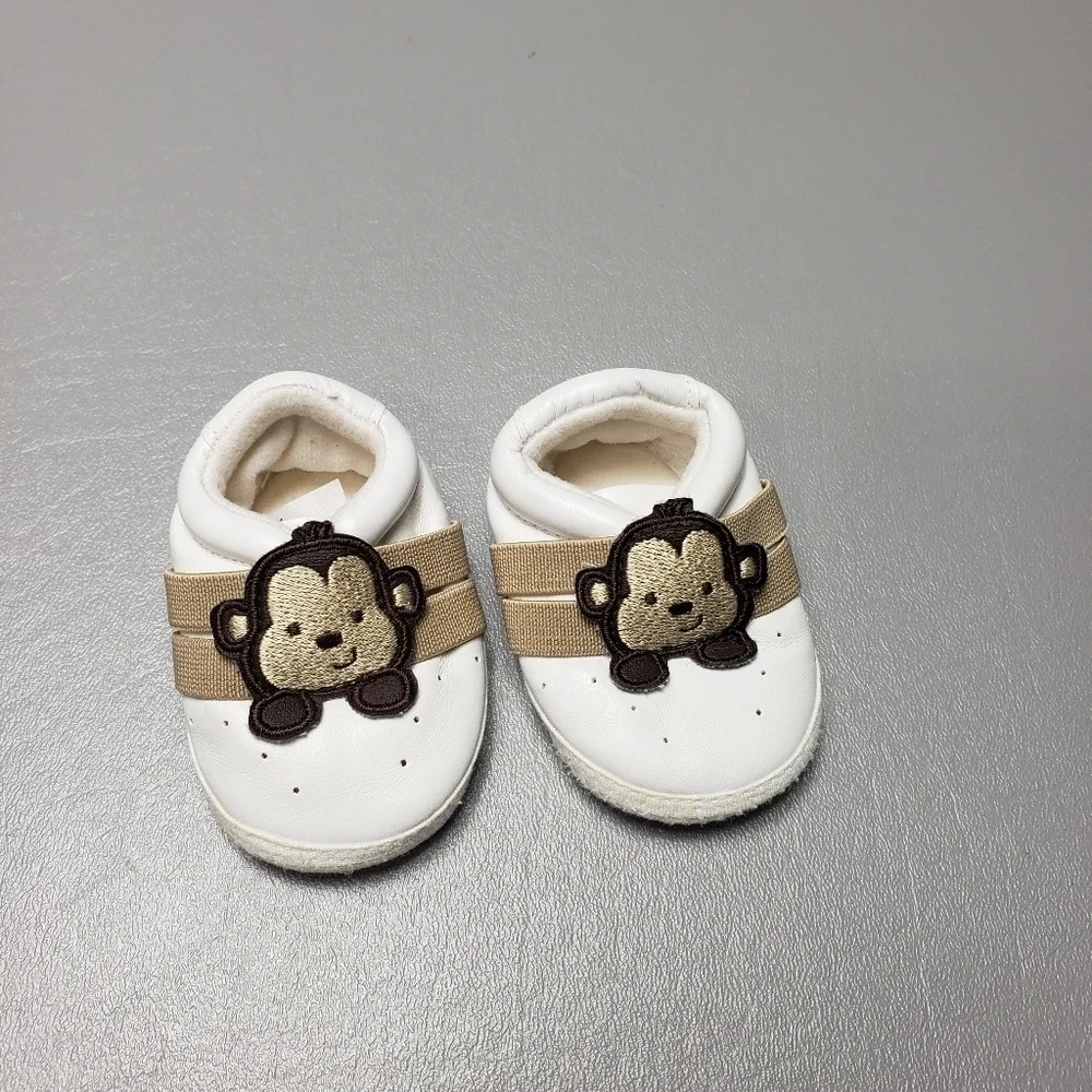 unbranded newborn white and brown gender neutral monkey shoes/slippers